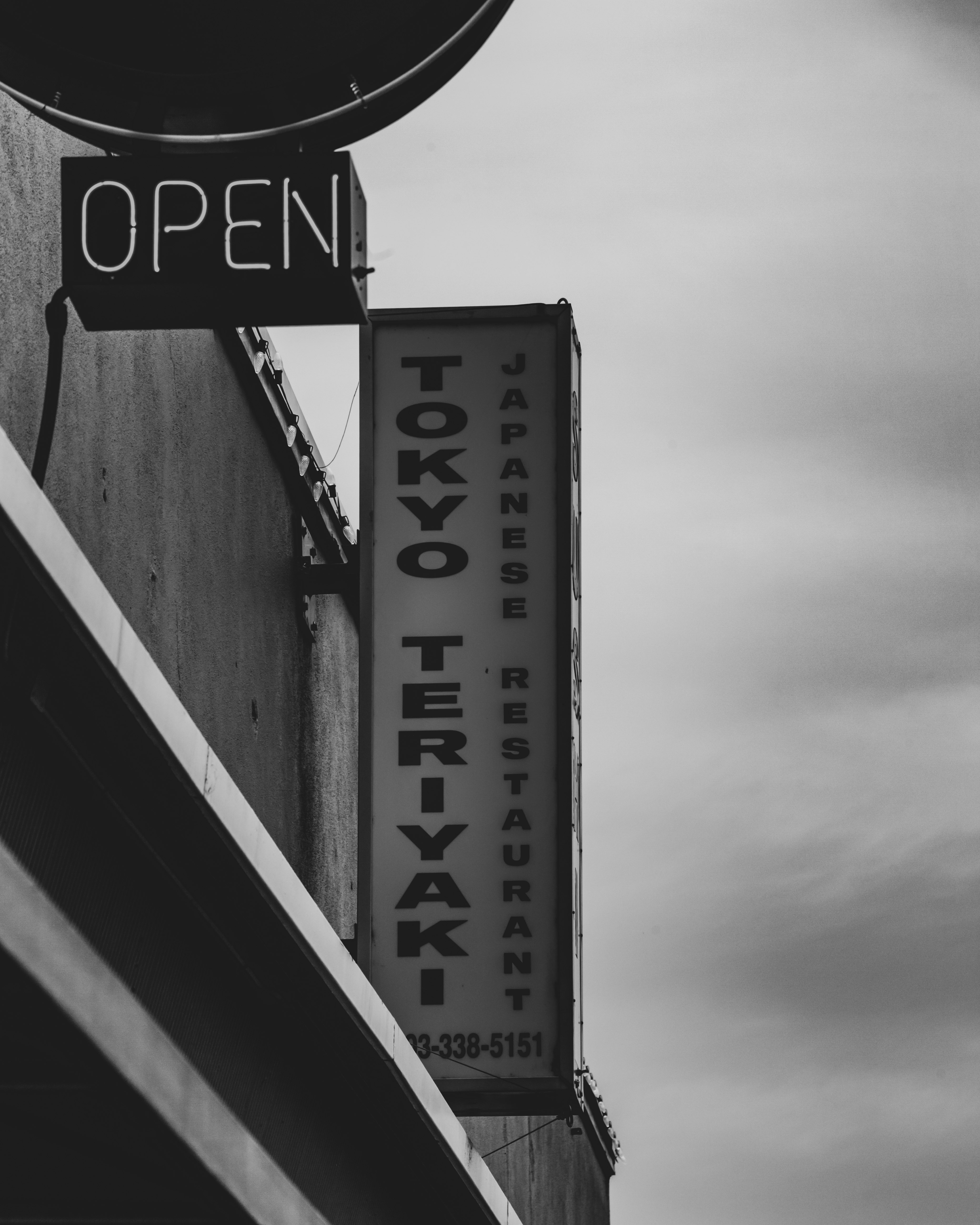 grayscale photo of UNK signage